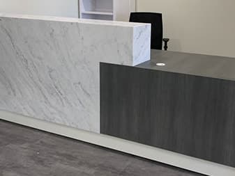 Reception desk with a marble-look solid-surface top